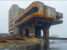 an old abandoned building sitting on top of a wet field