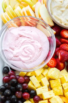 an assortment of fruits and dips on a platter