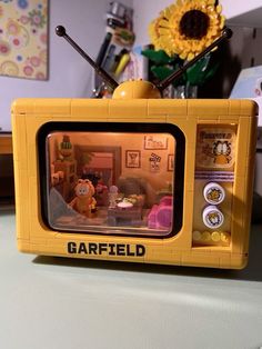 a yellow lego tv sitting on top of a table