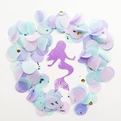 purple and blue confetti with mermaid silhouette on white background, surrounded by circles