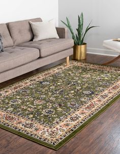 a living room with a couch and rug on the floor