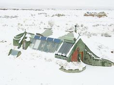 an aerial view of a building with snow on the ground