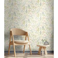 a chair and side table in front of a wallpapered room with plants on it