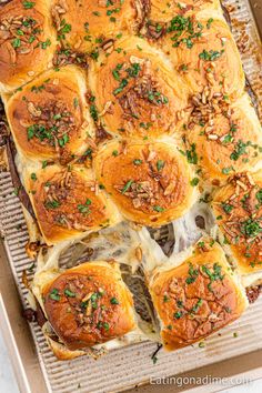 a pan filled with rolls covered in cheese and toppings