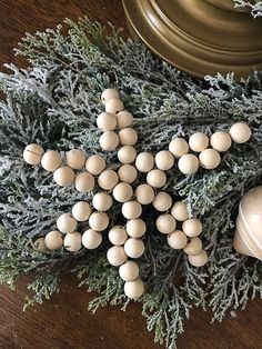 a cross made out of eggs sitting on top of a table next to a bell