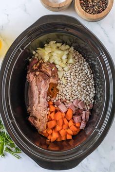 the ingredients for this slow cooker meal include carrots, beans, and meat