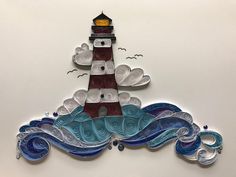 a paper cut lighthouse with waves and seagulls flying around it on a white background