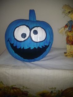 a blue pumpkin sitting on top of a table