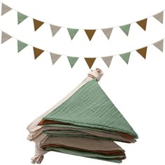 a stack of books sitting on top of a table next to a bunting flag