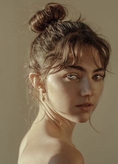 a beautiful young woman with blue eyes posing for the camera