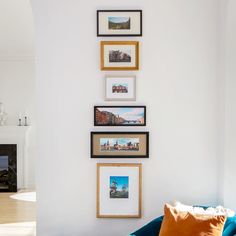 a living room filled with furniture and pictures on the wall next to a fire place