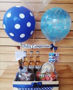 a table with balloons, drinks and condiments on it