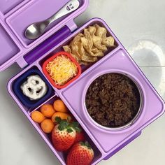 a purple lunch box filled with different foods