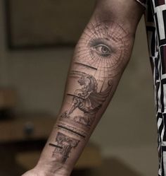 a man's arm with an all seeing eye tattoo on it