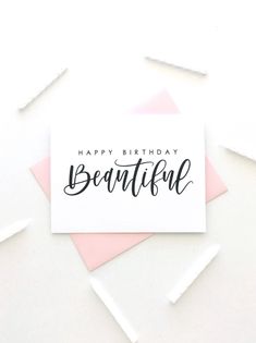 a card with the words happy birthday beautiful on it and some confetti sticks