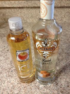 two bottles of alcohol sitting next to each other on a counter