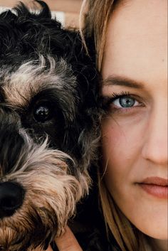 a close up of a person holding a dog