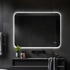 a bathroom with a sink, mirror and towel rack in it's dark room