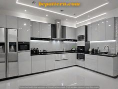 a modern kitchen with white cabinets and black counter tops is lit by recessed lighting