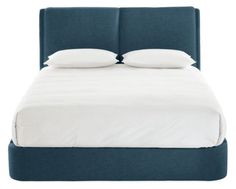 a bed with two pillows on top of it and white sheets in front of the headboard