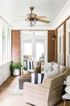 a living room filled with furniture and a ceiling fan