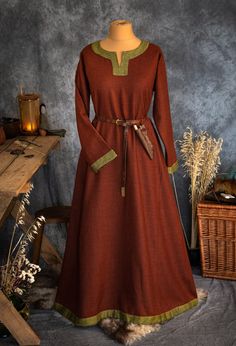 The dress has simple medieval cut with long sleeves, loose and comfortable. The historical pattern - an important element when playing historical realities, especially Vikings or Slavs. Put on your cloak and travel back to the Middle Ages. Hunting, ancient legends, the warmth of the hearth and our dress will give you an unforgettable experience. The simple cut of the dress allows you to move freely, as well as boldly add accessories to the dress. The dress will perfectly fit into the basic wardr Viking Style Long Sleeve Medieval Dress, Simple Medieval Dress, Viking Coat, Slavic Dress, Viking Cloak, Celtic Dress, Viking Decor, Viking Dress, Medieval Clothes