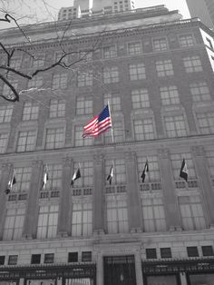 an american flag flying in front of a building