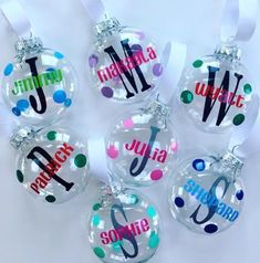 six personalized christmas ornaments hanging from ribbon