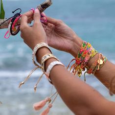 A model wearing the Jungle Bali Friendship Bracelet Bundle from Love Is Project Tropical Bracelets, Green School Bali, Alice Core, Tag Sticker, Cloth Pouch, Woven Bracelets, Good Friends, Women Artisans, Jewelry Inspo