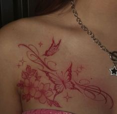 the back of a woman's shoulder with flowers and butterflies tattoo on her chest