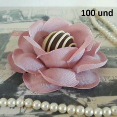 a necklace with pearls and a flower on it