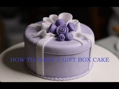 a cake that is sitting on top of a plate with the words how to make a gift box cake