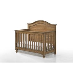 a wooden crib with white sheets on the bottom and sides, against a white background