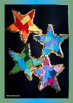 four stars made out of colored paper on a black background