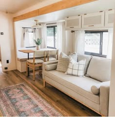 a living room filled with furniture and a rug