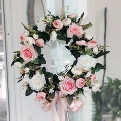 a wreath with pink and white flowers on it