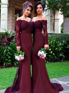 two women in long dresses standing next to each other