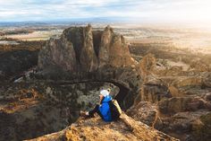 a person sitting on top of a mountain