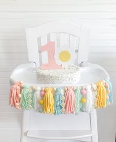 a birthday cake sitting on top of a white chair