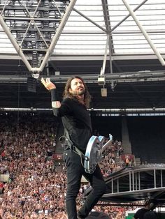 a man standing on top of a stage in front of a crowd