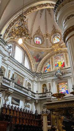 the inside of a church with many stained glass windows