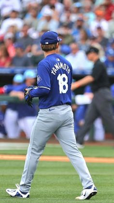 a baseball player standing on top of a field next to a crowd in the stands