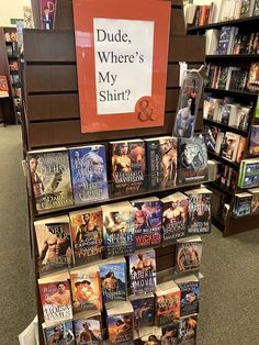 there are many books on display in the store and one has a sign that says dude, where's my shirt?