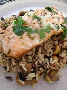 a white plate topped with fish and rice