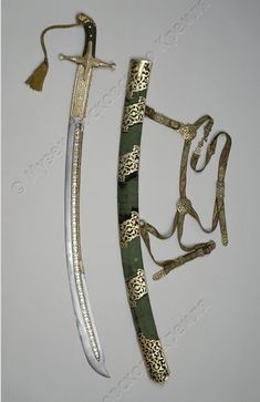 two different types of swords are displayed on a white surface with gold trimmings