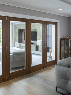 a living room filled with furniture and sliding glass doors