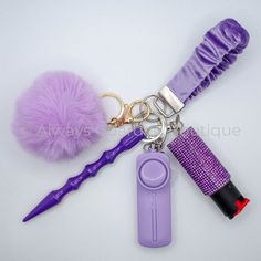 a purple key chain with some hair accessories on it