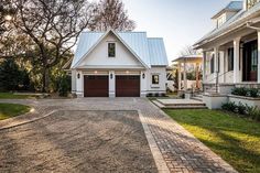 a large white house with two garages