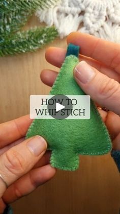 someone is holding a small felt christmas tree ornament in their left hand, with the words how to whimsich on it