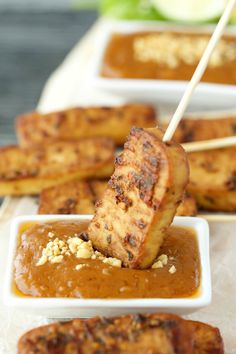 grilled chicken skewers with peanut sauce and garnish on a stick